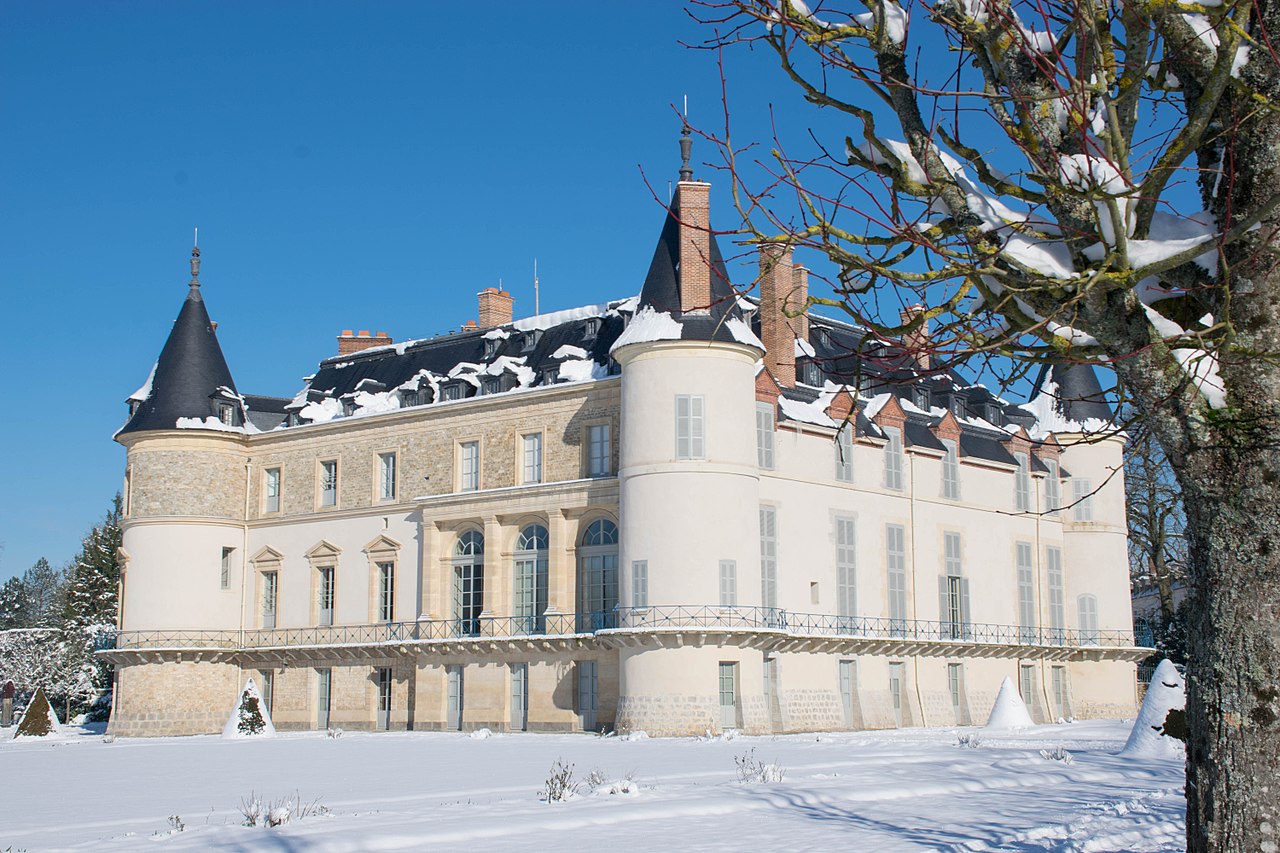 Stunning snowy path through a winter forest in Ebensee, Austria, with sunlight filtering through trees.